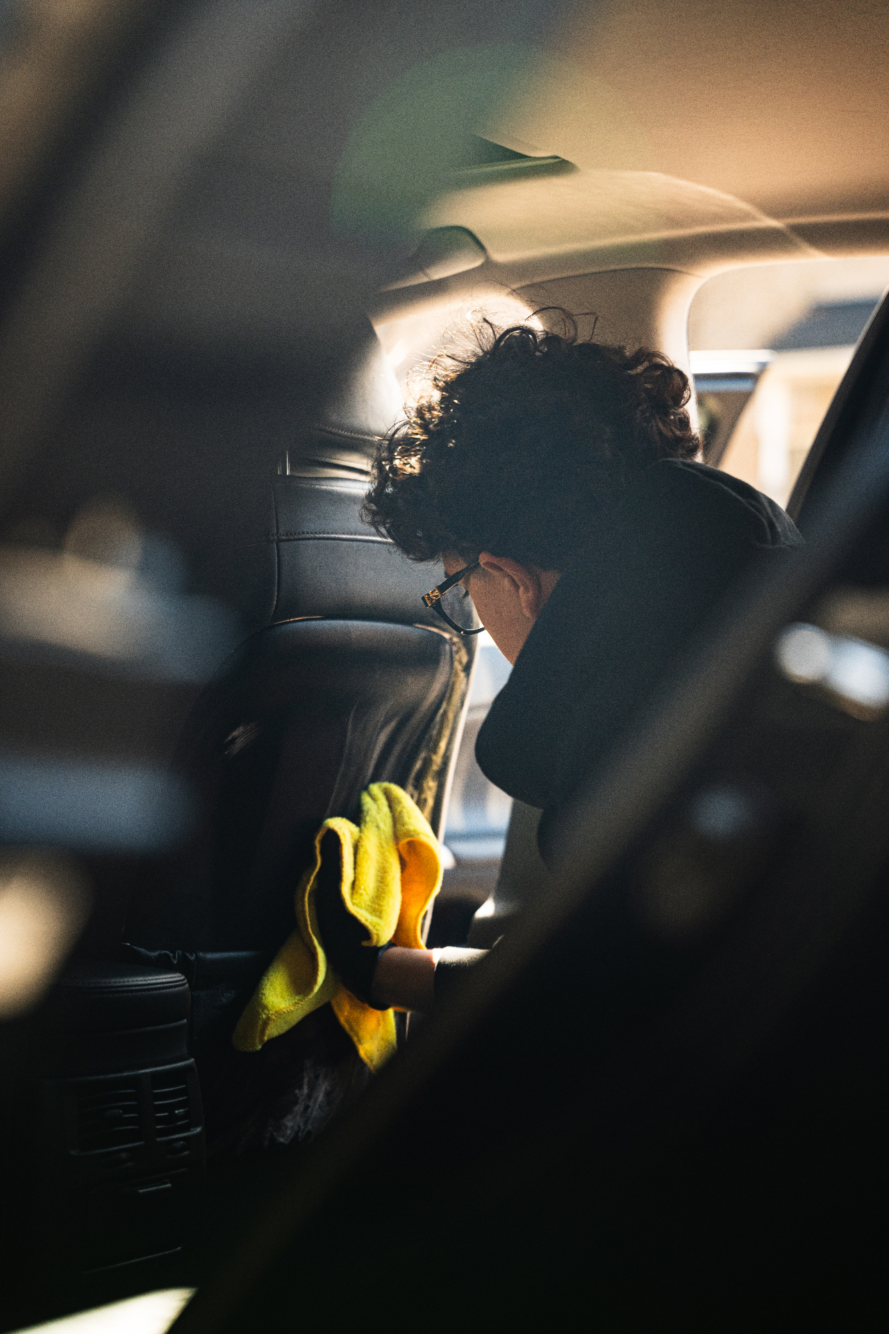 Detailer hand-polishing a luxury car interior